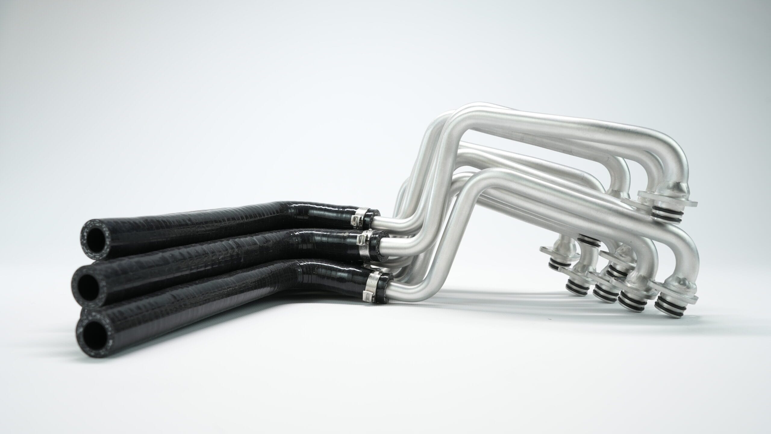 Silicone Hose | Silicone Hose Manufacturer UK. Black silicone hose and metal tube assembly.